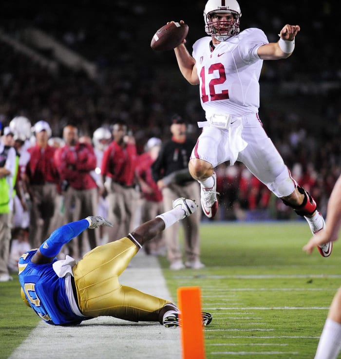September 11, 2010; Pasadena, CA, USA; Stanford Cardinal quarterback Andrew Luck (12) leaps to throw a pass against the UCLA Bruins during the first half at the Rose Bowl. Mandatory Credit: Gary A. Vasquez-USA TODAY Sports